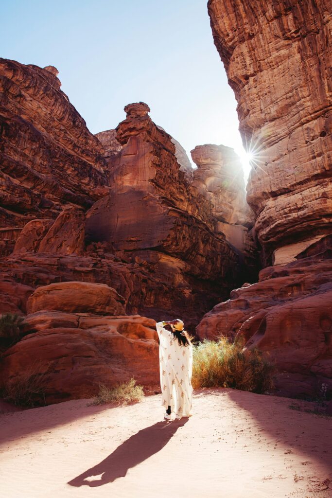 A woman standing in the middle of a desert