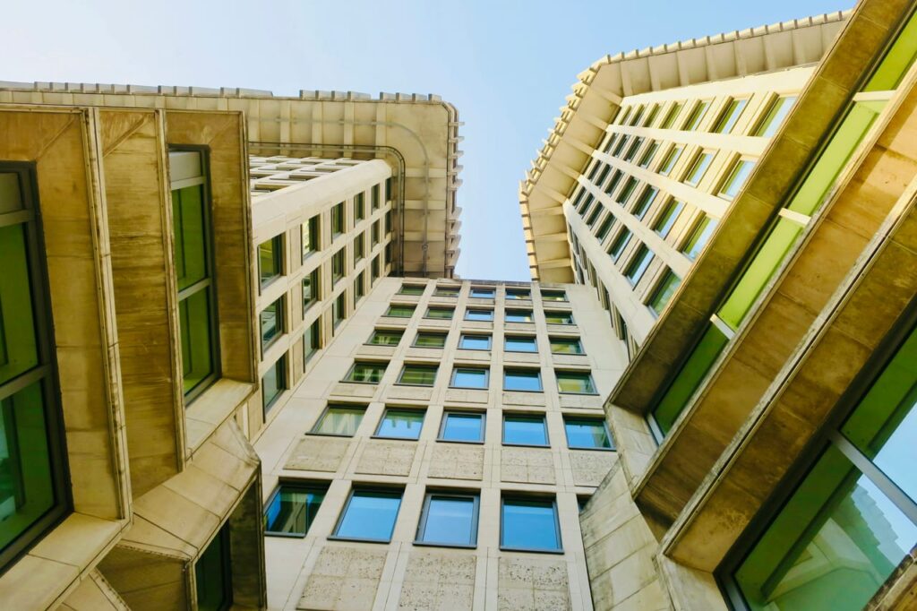 A tall building with lots of windows next to another building