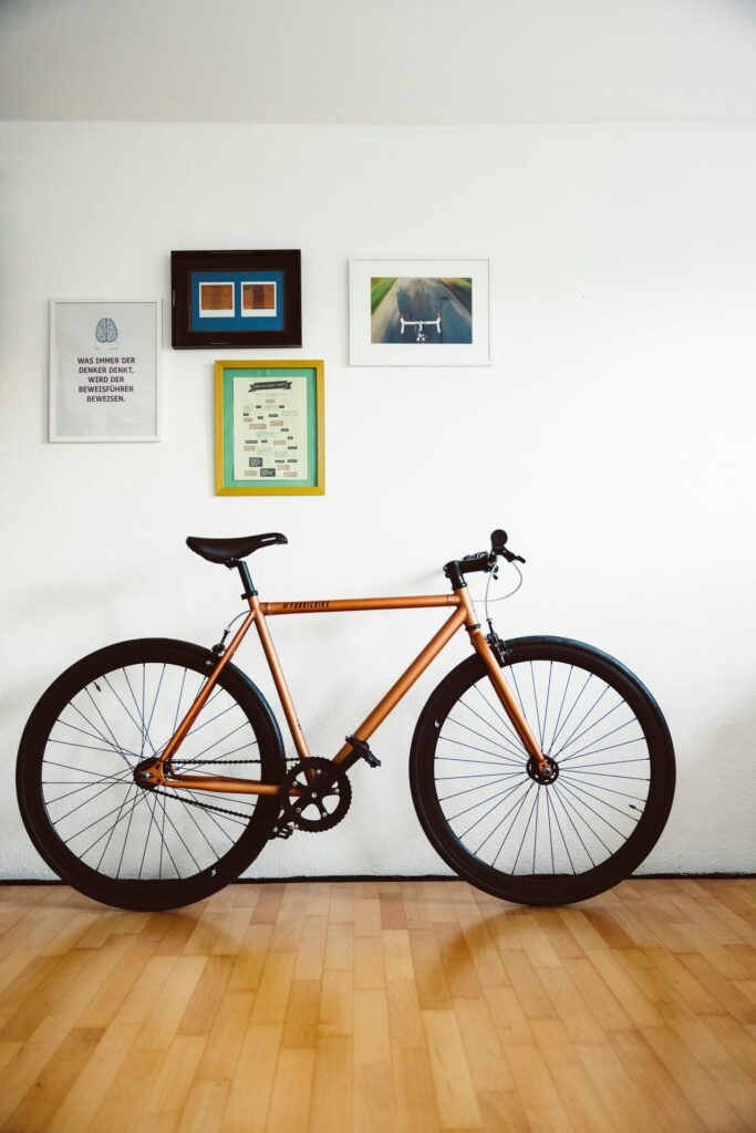 A bike parked against a wall in a room