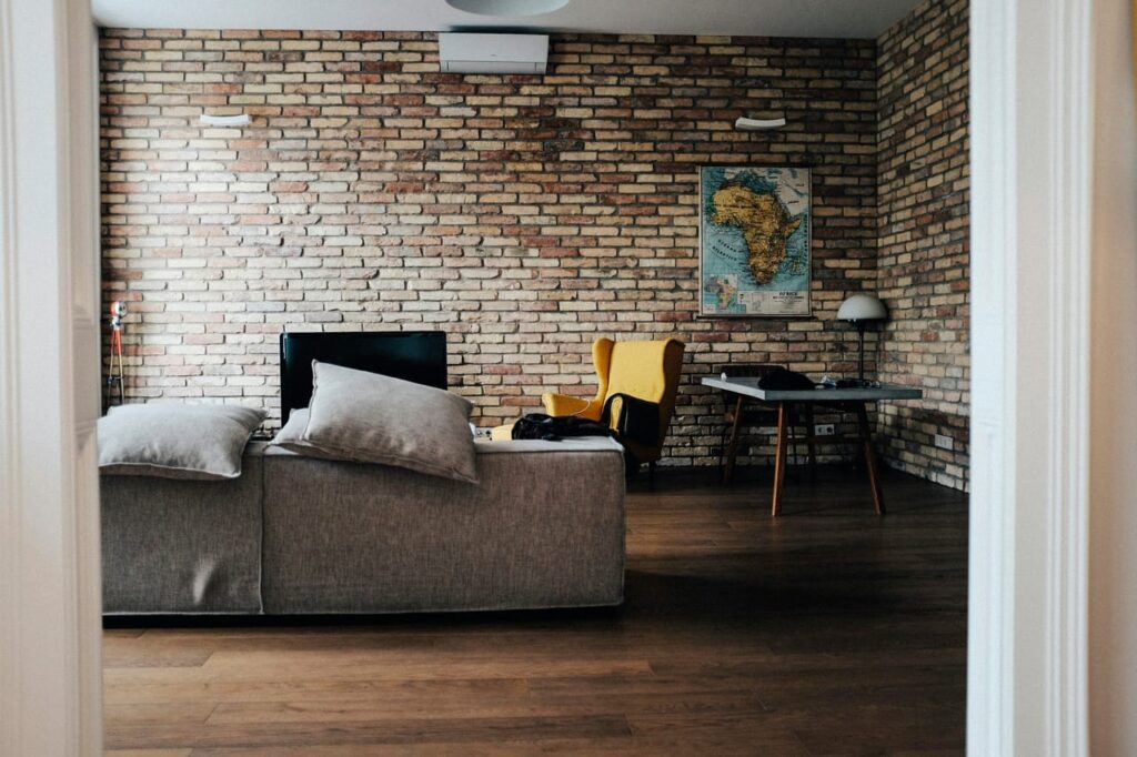 Gray wooden table beside wing chair