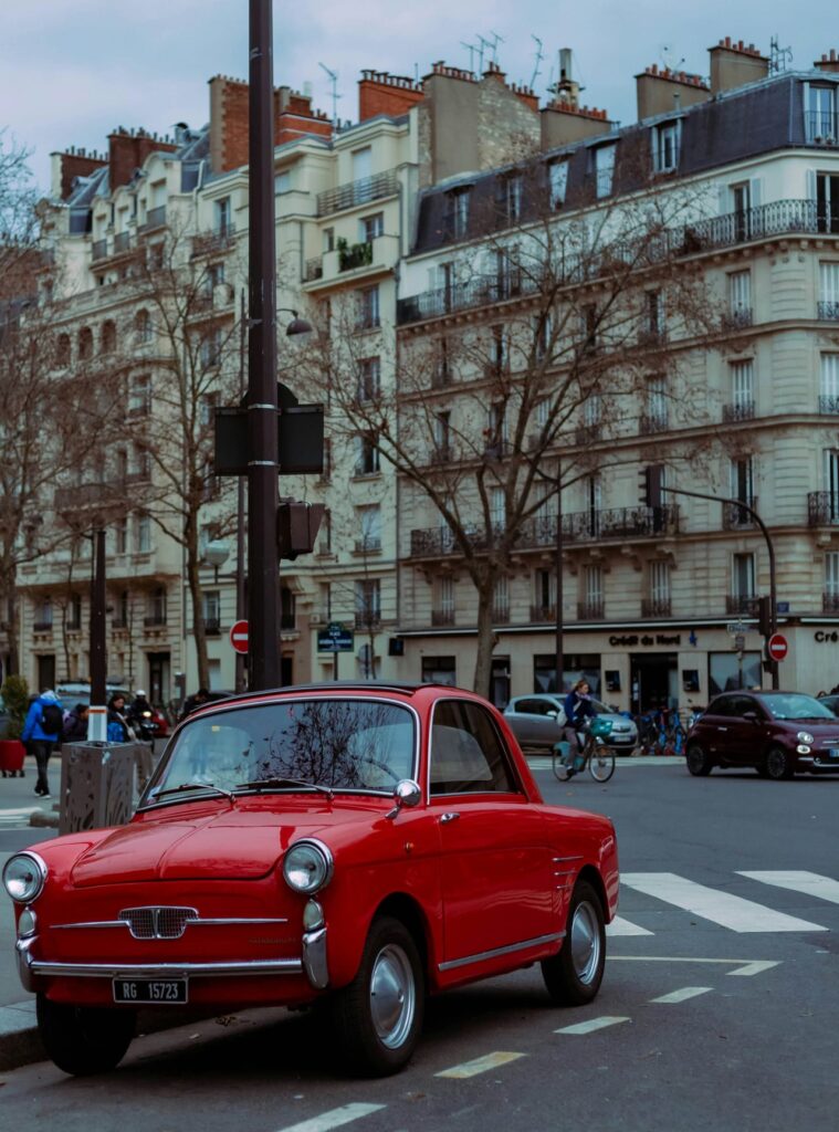 A red car parked on the side of the road